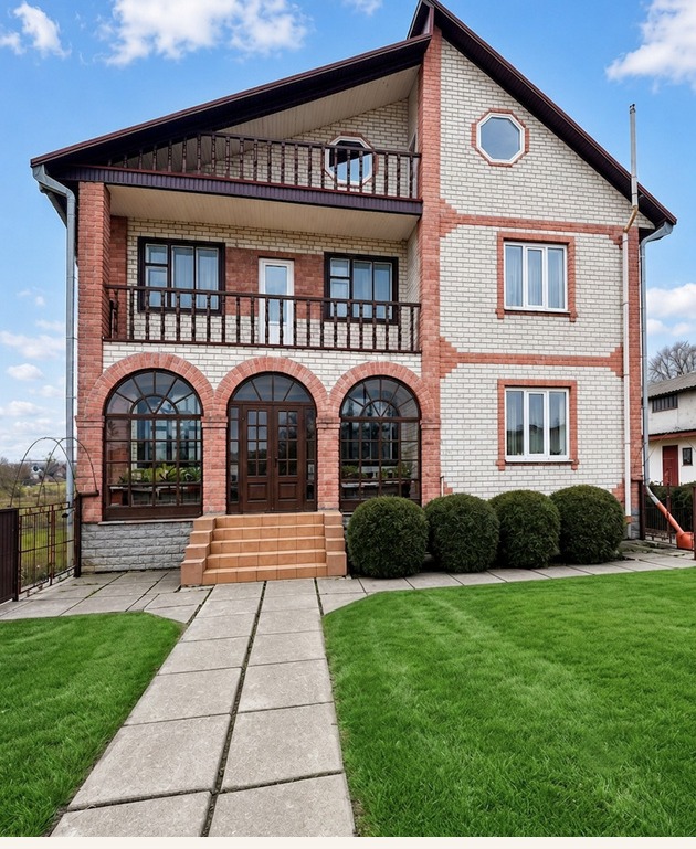 House exterior photo with sky and landscaping enhancement, after editing